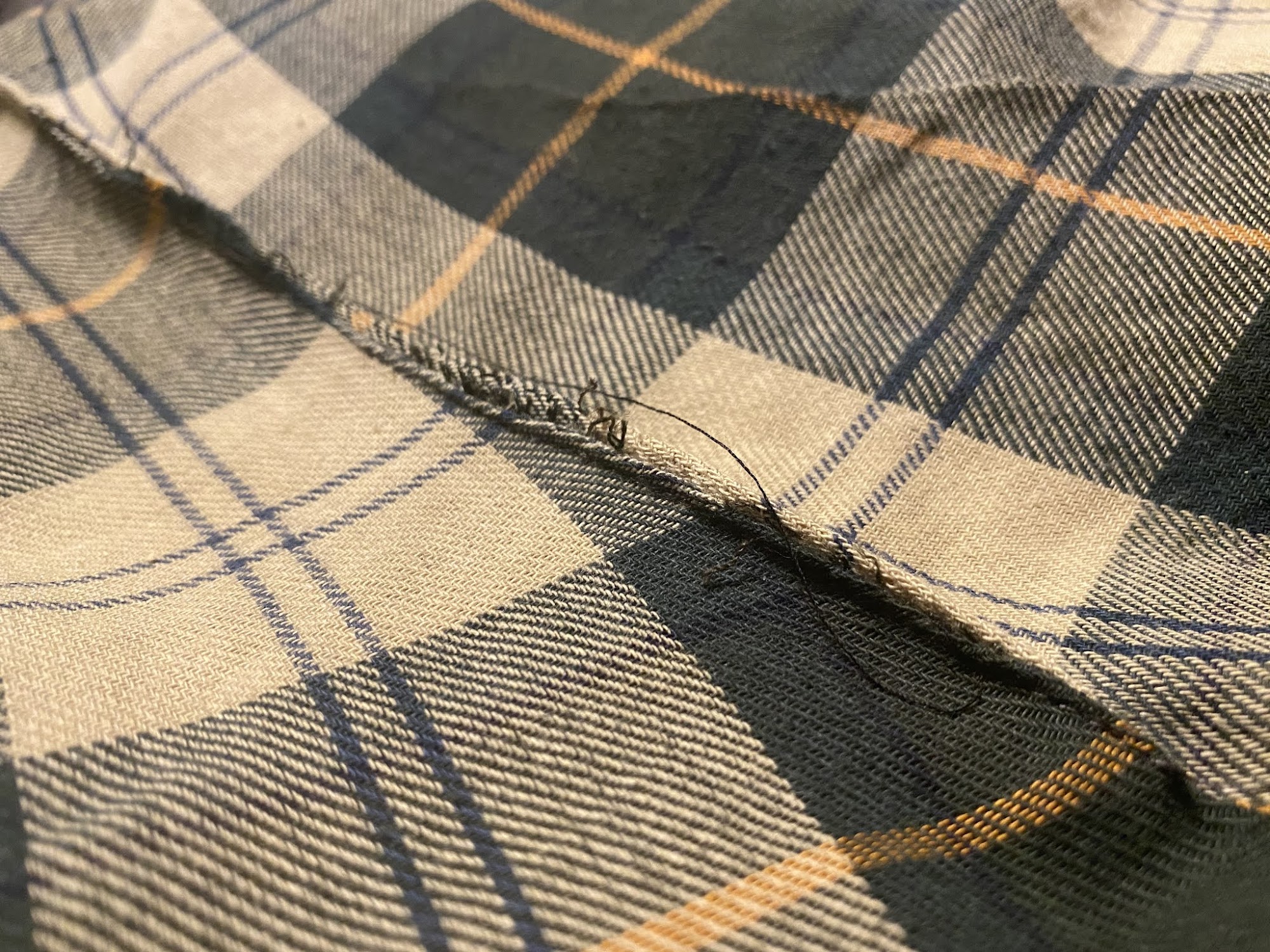 Close detail of a seam in plaid fabric